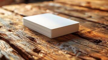 A stack of white cards is on a wooden table photo