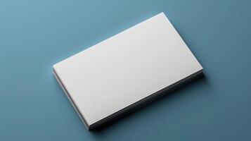 A white business card sits on a blue surface photo