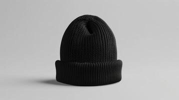 A black knit hat is sitting on a white background photo