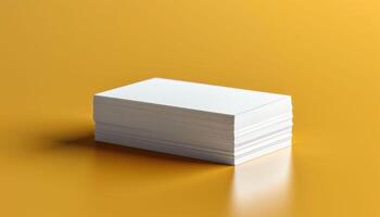 A stack of white business cards on a yellow table photo