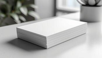 A stack of white paper is on a table photo