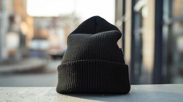 A black knit hat is sitting on a table photo