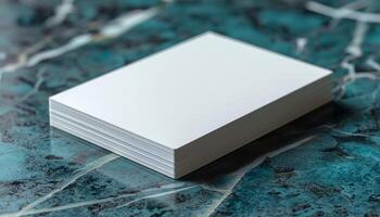 A stack of white paper is on a blue surface photo