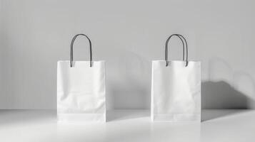 Two white bags with black handles are displayed on a white table photo