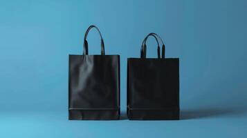 Two black bags are displayed on a blue background photo
