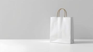A white bag with a brown handle sits on a table photo