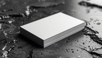 A white business card sits on a black surface photo