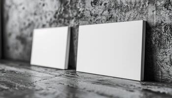 Two white business cards are displayed on a wall photo