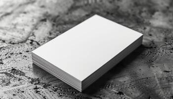 A white business card sits on a grey surface photo