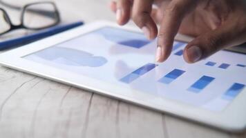 A business person using a tablet with a graph on it video