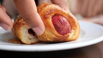 A plate filled with delicious puff pastry that is generously stuffed with savory sausage video