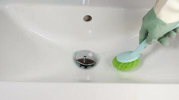 To effectively clean and maintain a bathroom sink, utilizing a scrubbing brush is essential video