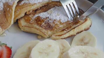 These delicious pancakes are served with fresh fruit slices and a sprinkle of powdered sugar video