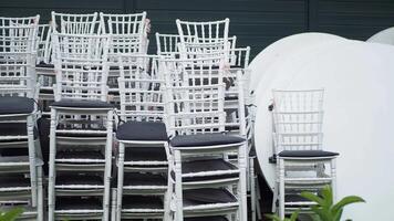 Neatly Stacked White Chairs and Tables Are All Prepared for the Upcoming Event Setup video