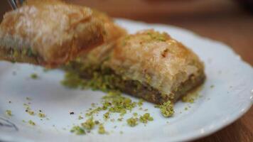 A scrumptious and delicious Baklava adorned with Pistachios elegantly presented on a Plate video