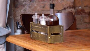 An inviting rustic table setup accompanied by a condiment holder and a wooden surface video
