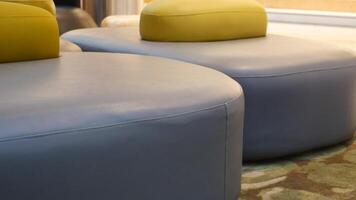 Stylish and Modern Lounge Seating Featuring Soft Curves Accompanied by Colorful Cushions video
