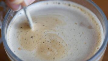 Gently stirring coffee with care to create a perfectly creamy and delightful foam texture video