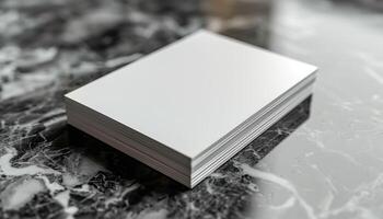 A stack of white paper is on a marble countertop photo