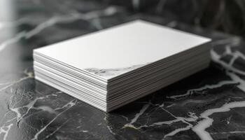 A stack of white business cards with a mountain on the bottom photo
