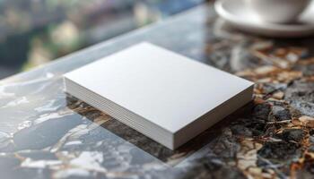 A white card is sitting on a table with a cup photo