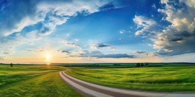 asphalt road through the green field and clouds on blue sky in summer day photo