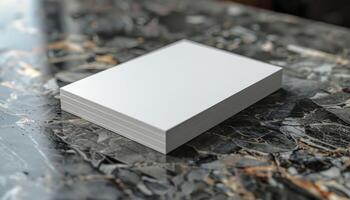A stack of white paper is on a marble countertop photo