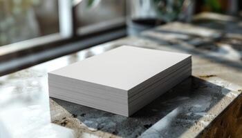 A stack of white paper is on a table photo