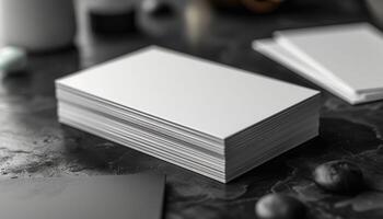 A stack of white business cards sits on a table photo