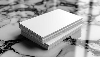 A stack of white business cards on a marble countertop photo