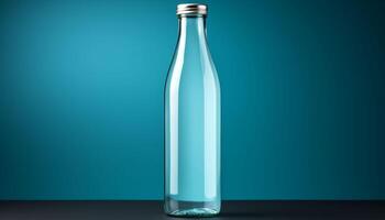 A glass bottle is sitting on a table photo