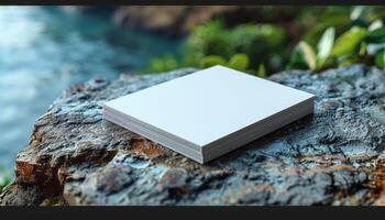 A white piece of paper is on a rock by the water photo