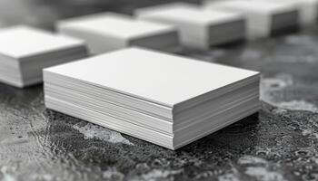 A stack of white business cards is on a table photo