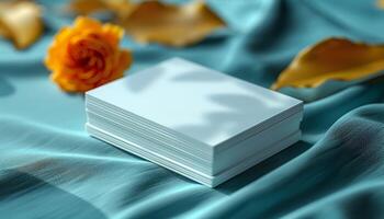 A stack of white cards with a rose on top photo