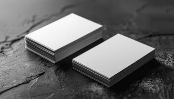Two white business cards are stacked on top of each other photo
