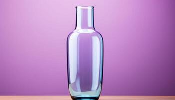 A clear glass vase sits on a wooden table photo