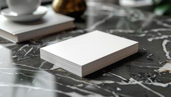 A white card is sitting on a table with a cup and a vase photo