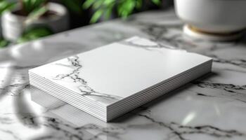 A white book with a marble pattern on it sits on a marble table photo