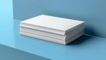 A stack of white business cards on a blue surface photo