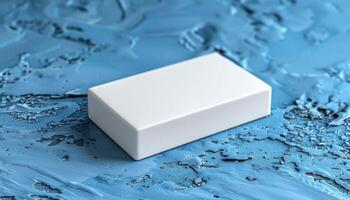 A white box is on a blue surface photo