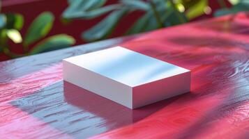 A white box sits on a red table photo