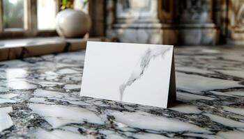 A white card with a triangle shape is on a marble floor photo