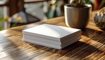 A stack of white papers sits on a wooden table next to a potted plant photo