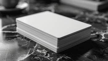 A stack of white cards is on a table photo