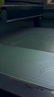 Piece of frosted glass is decorated with lines. Picture is applied on the future door by the automated tool machine. Vertical video