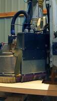 Polishing the wooden part of the future door. Automatic tool machine moves over the surface of timber plank. Vertical video