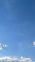 Clouds formation in the atmosphere. Beautiful cloudscape gathering quickly in the blue sky. Timelapse. Vertical video