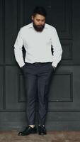 Gentleman posing in studio. Portrait of stylish handsome man with beard in studio Vertical video