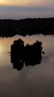 Reflection of sun in water. Aerial view of reflection of sunset in the water. Vertical video