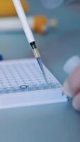 Science laboratory research. Close up view of scientist holds and examine samples Vertical video